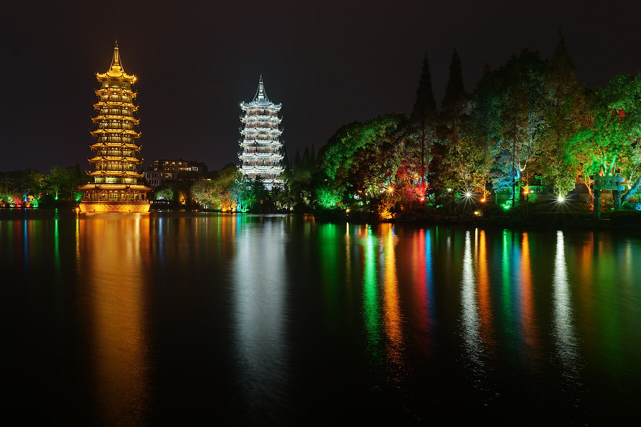 The Sun and Moon Pagodas lit at night on the lake in Guilin