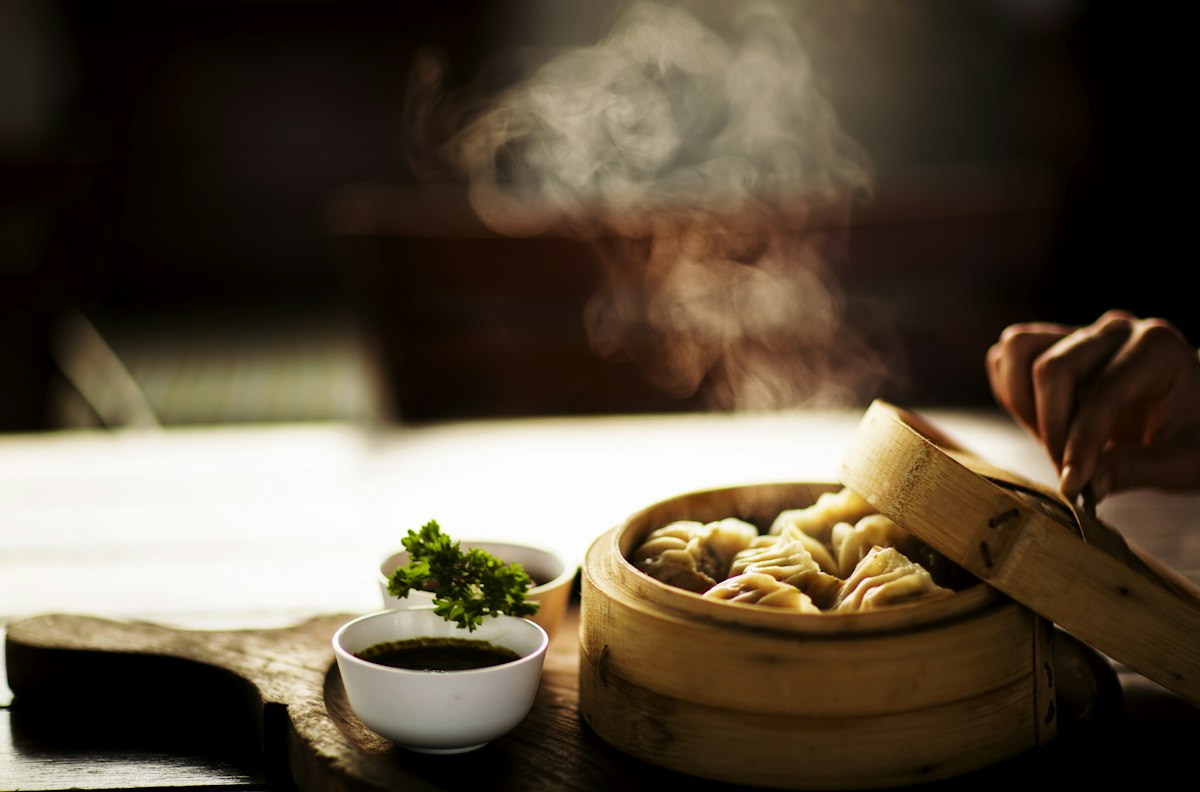 Dim sum in bamboo steamers on a restaurant table